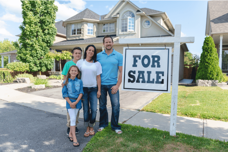 family with home sale board